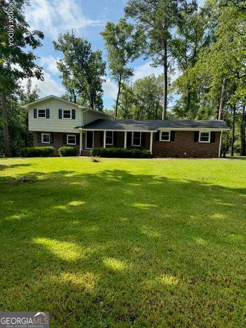 a front view of house with yard and green space