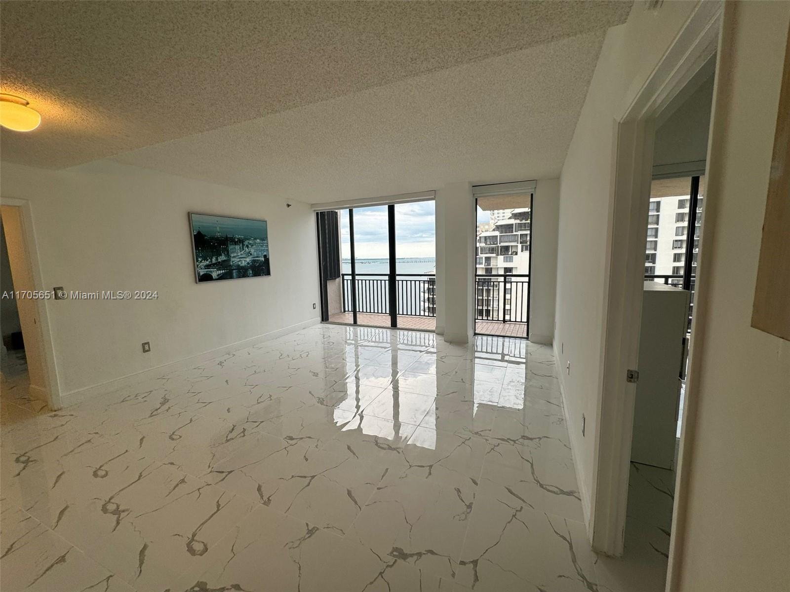 a view of empty room with floor to ceiling window