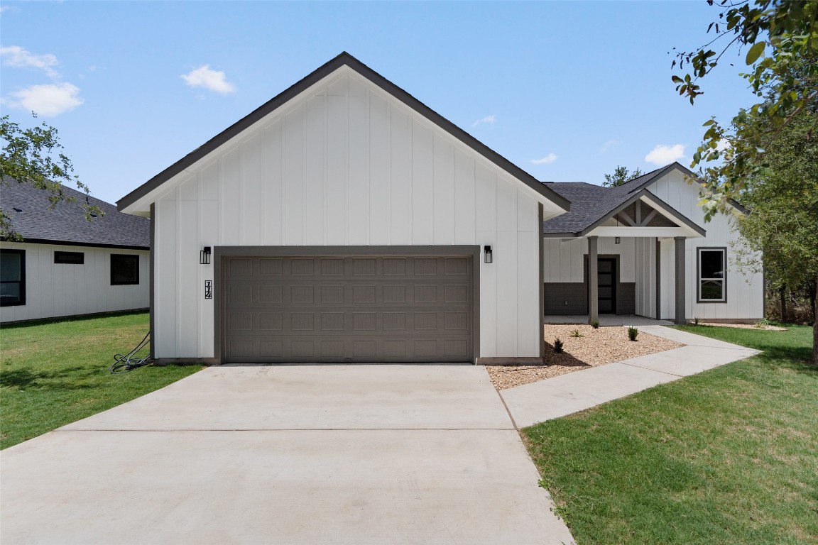 a front view of house with yard and green space