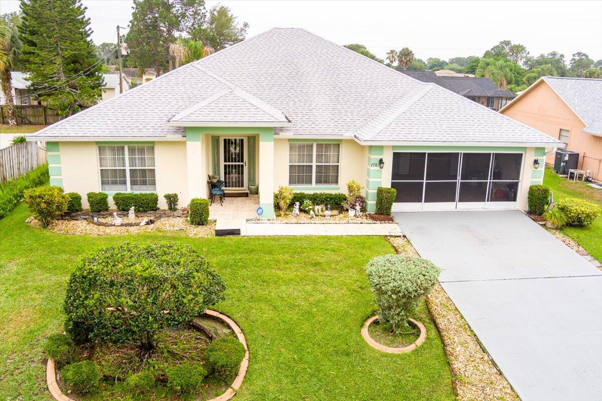 a front view of a house with garden