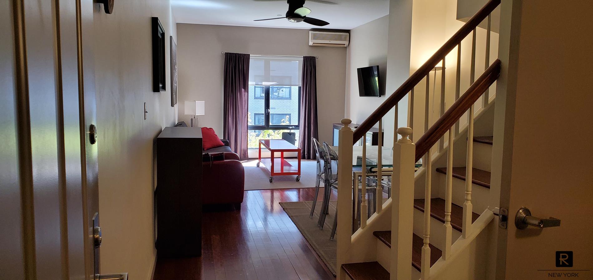 a view of entryway and hall with wooden floor