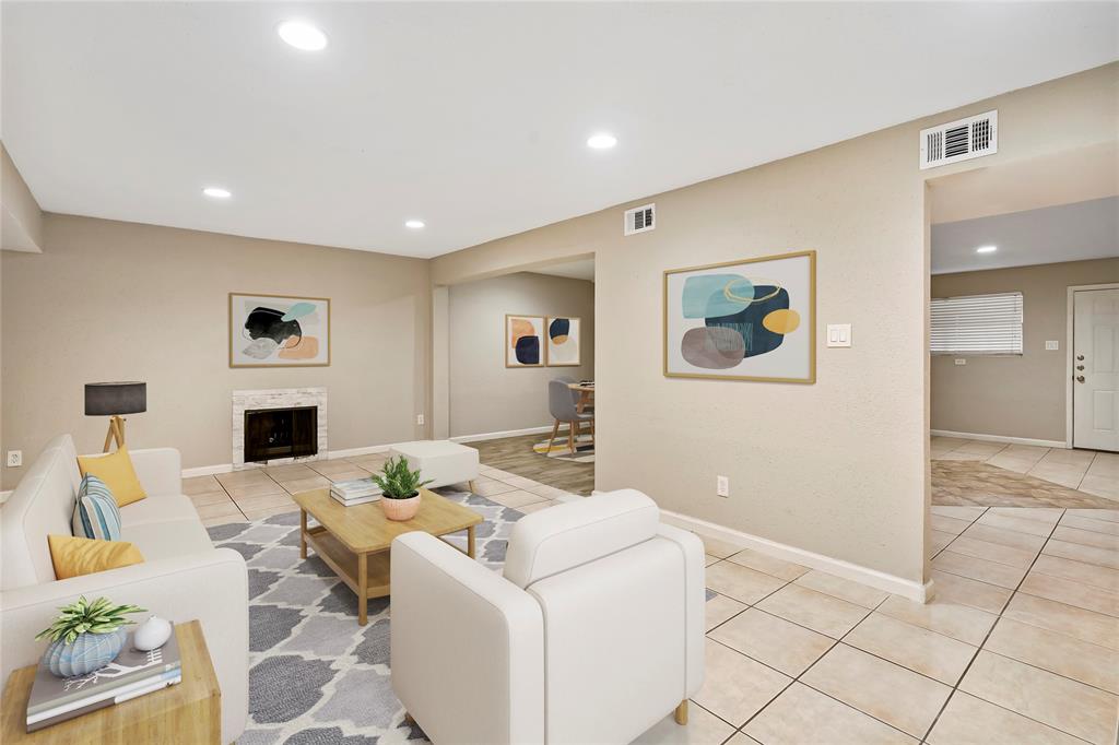 a living room with fireplace furniture and a flat screen tv