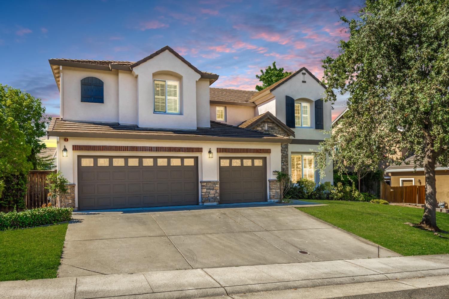 a front view of a house with a yard and garage