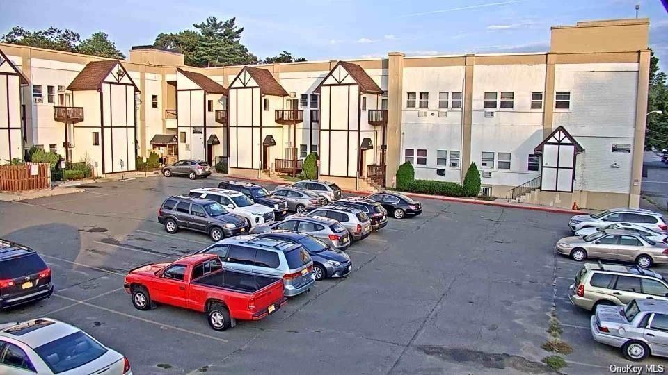 a couple of cars parked in front of a building