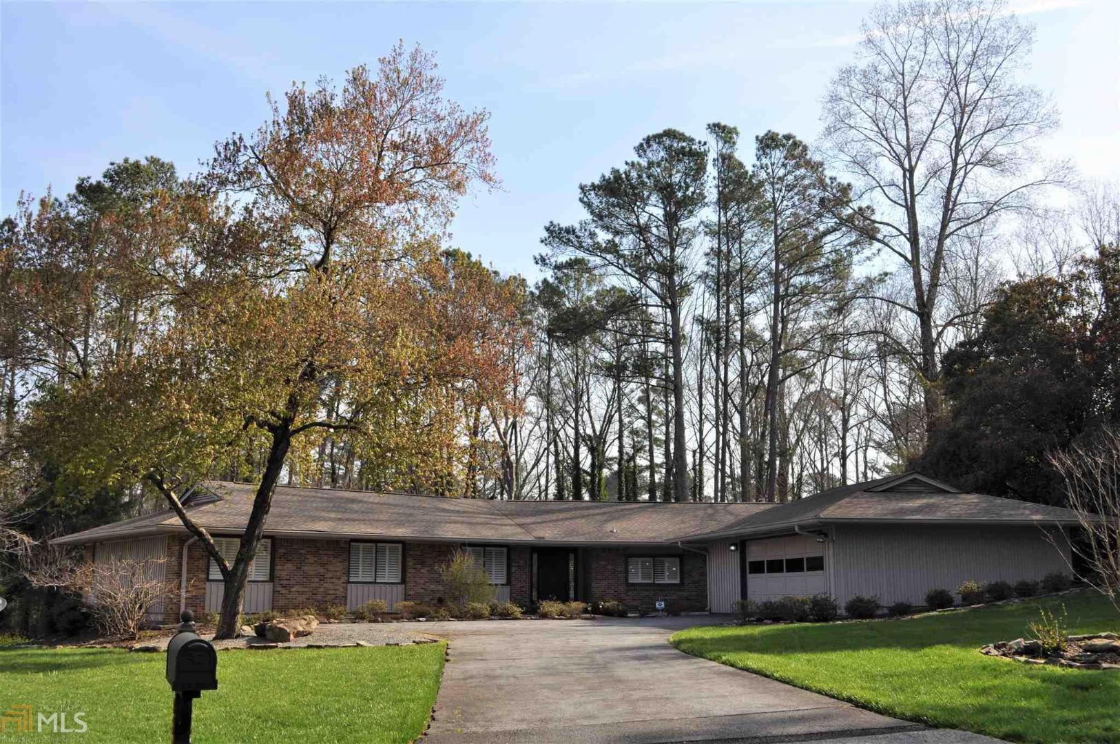 a front view of house with yard and trees