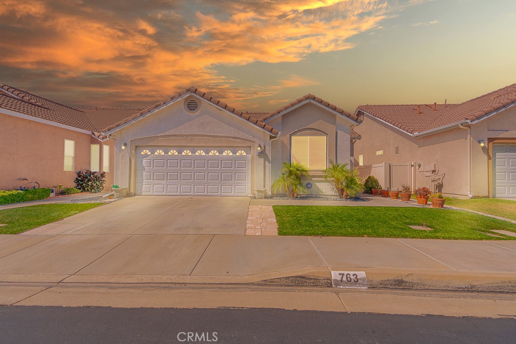 a front view of a house with a yard and garage