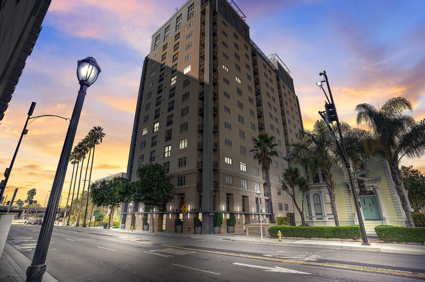 a view of a tall building next to a road