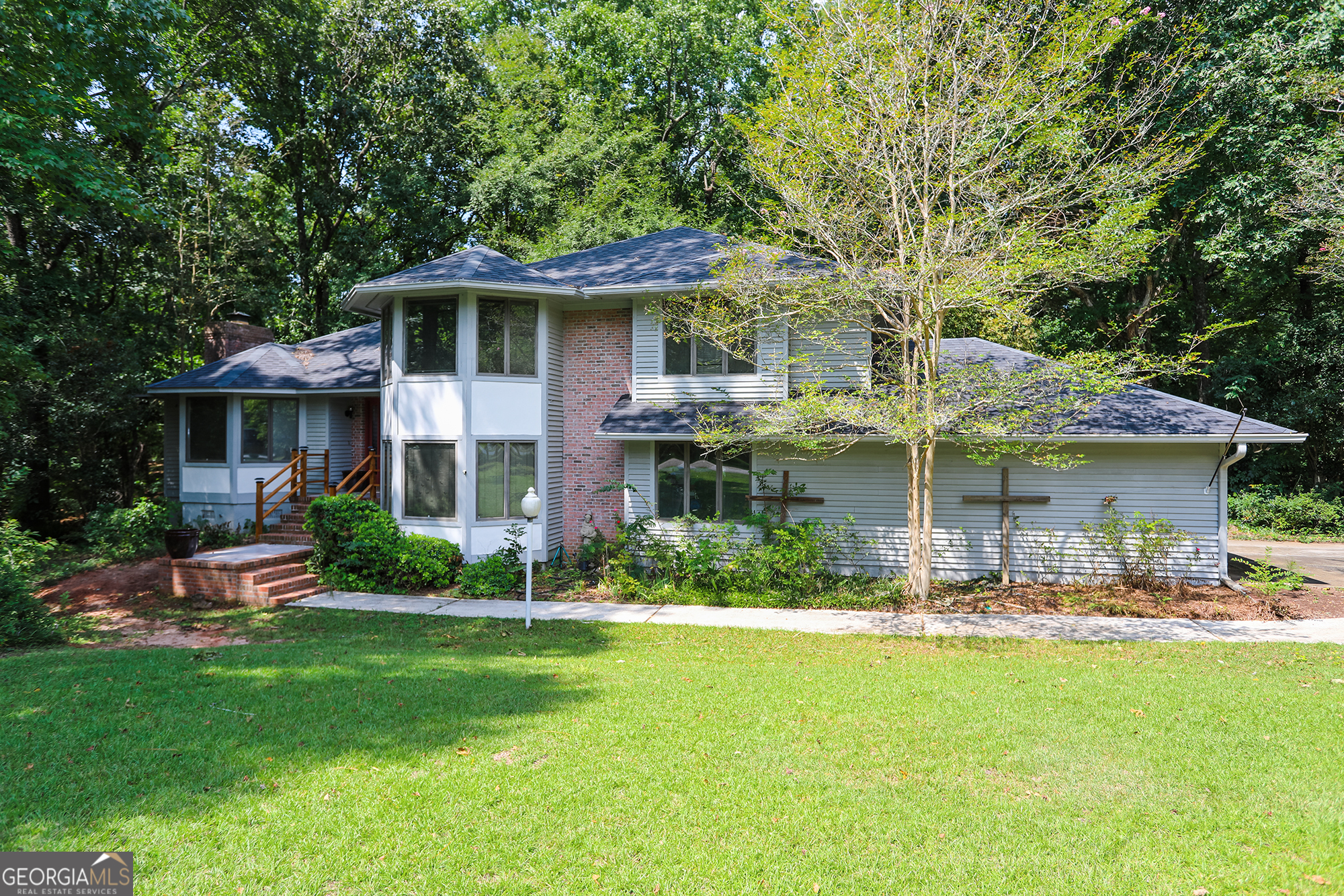 a front view of a house with garden