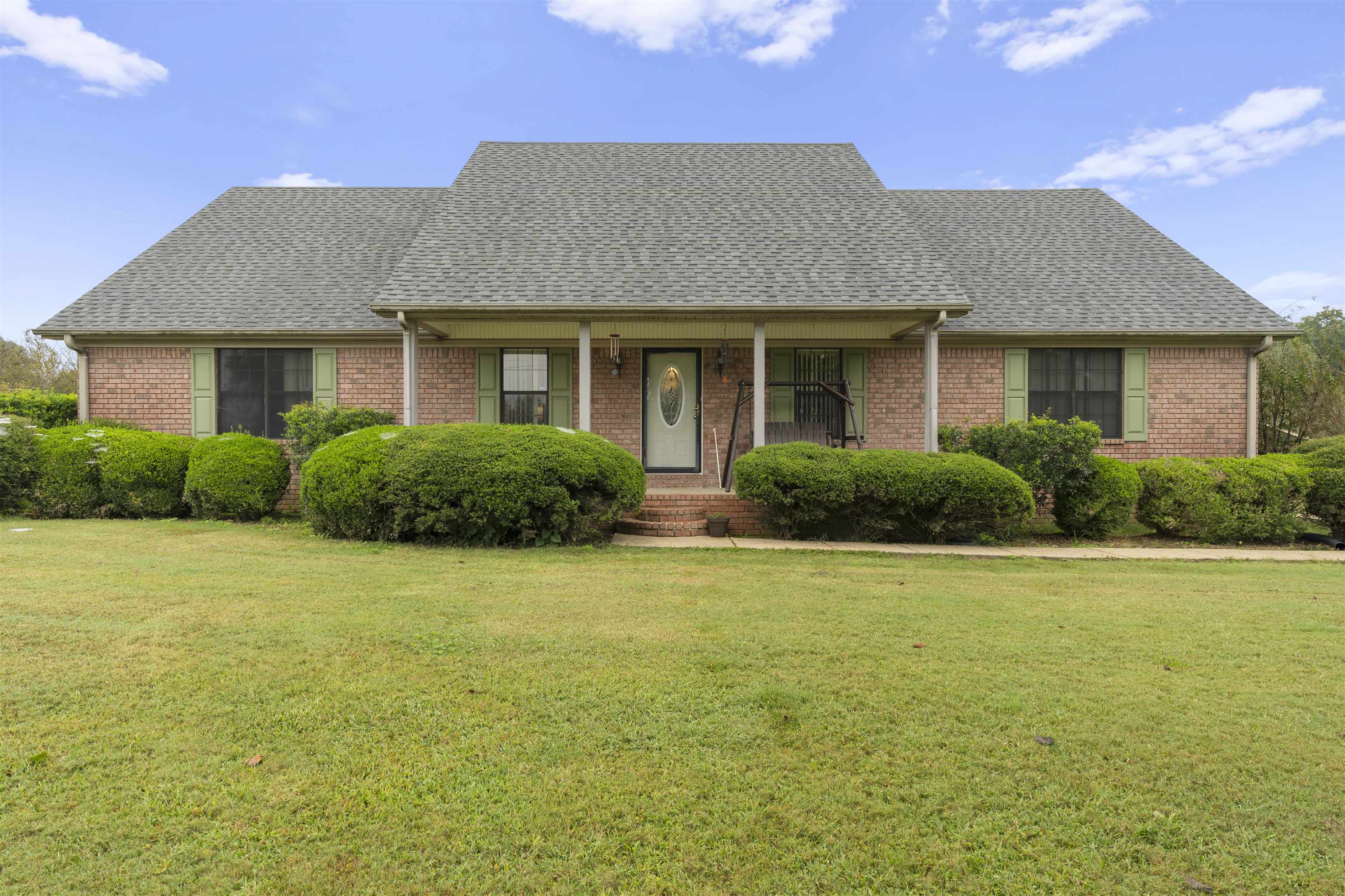 a front view of house with yard and green space