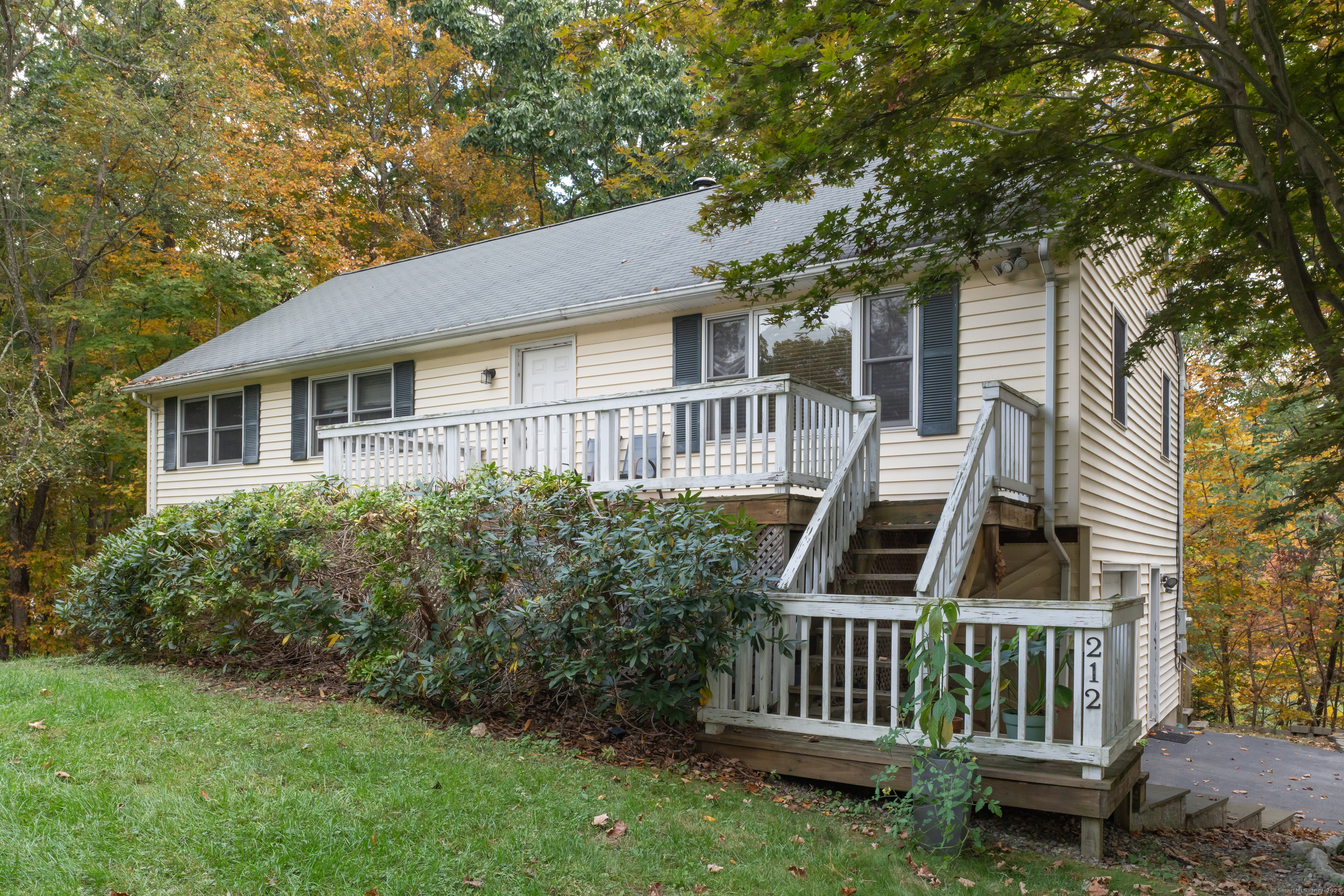 a front view of a house with garden and deck