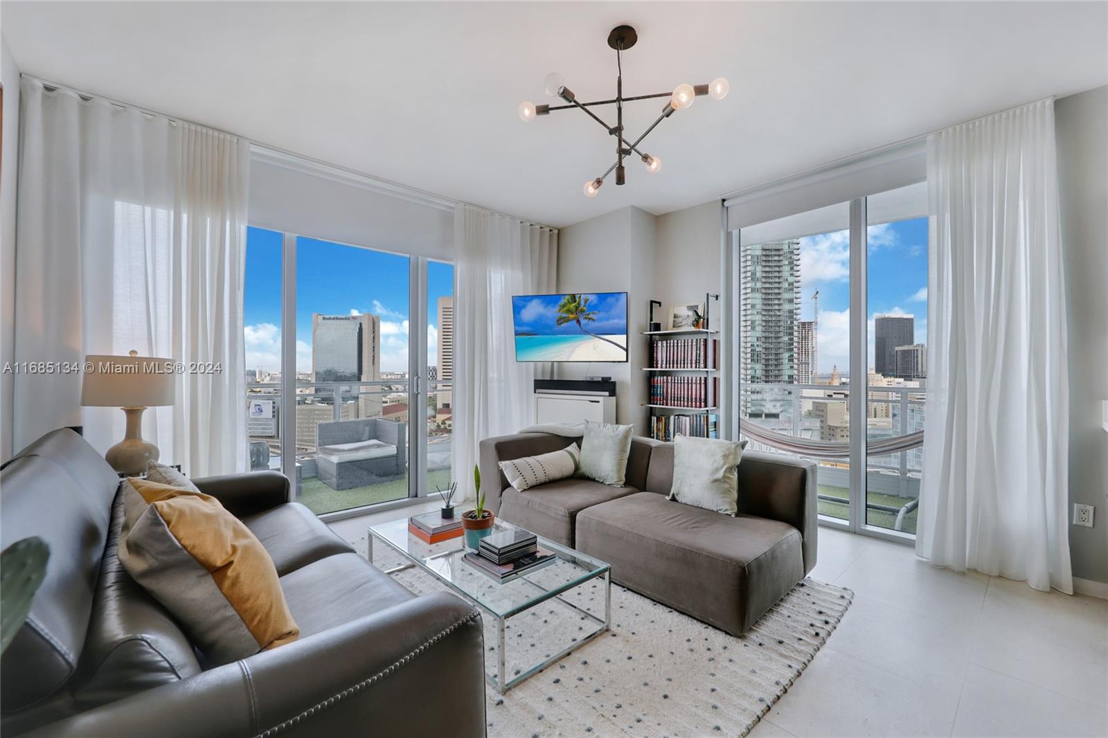 a living room with furniture and a glass door