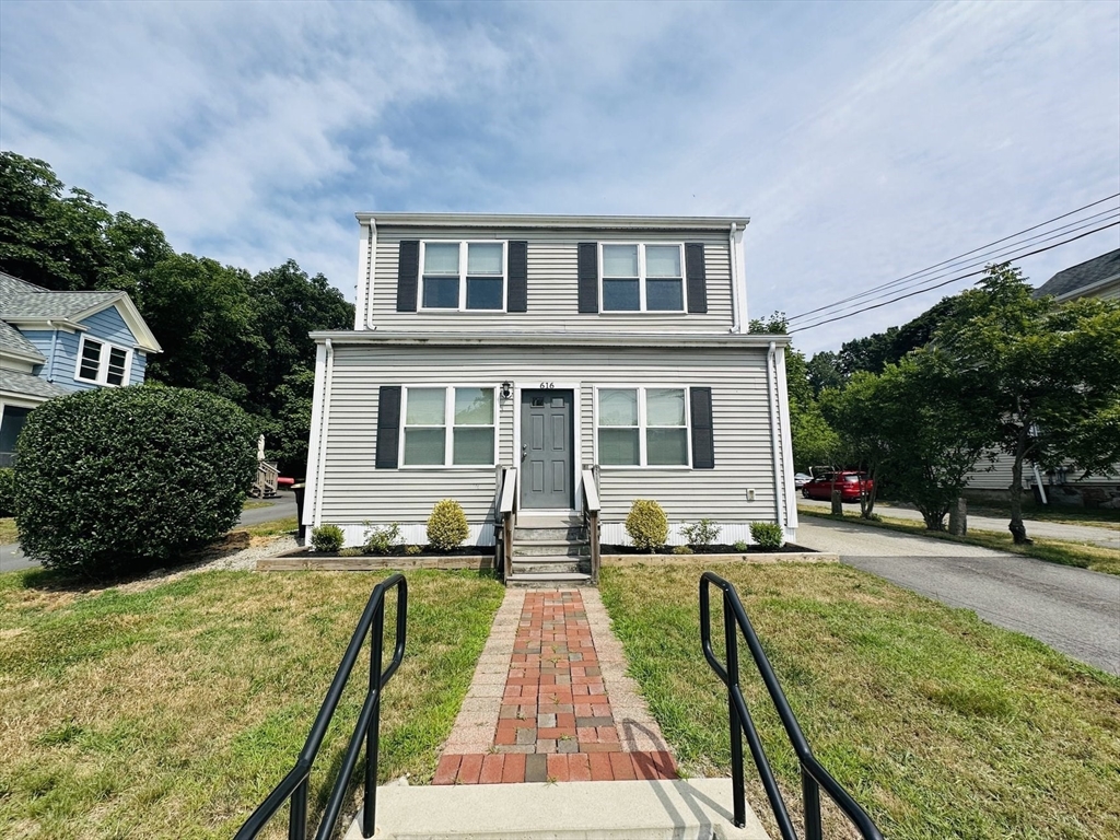 a view of a house with a yard patio