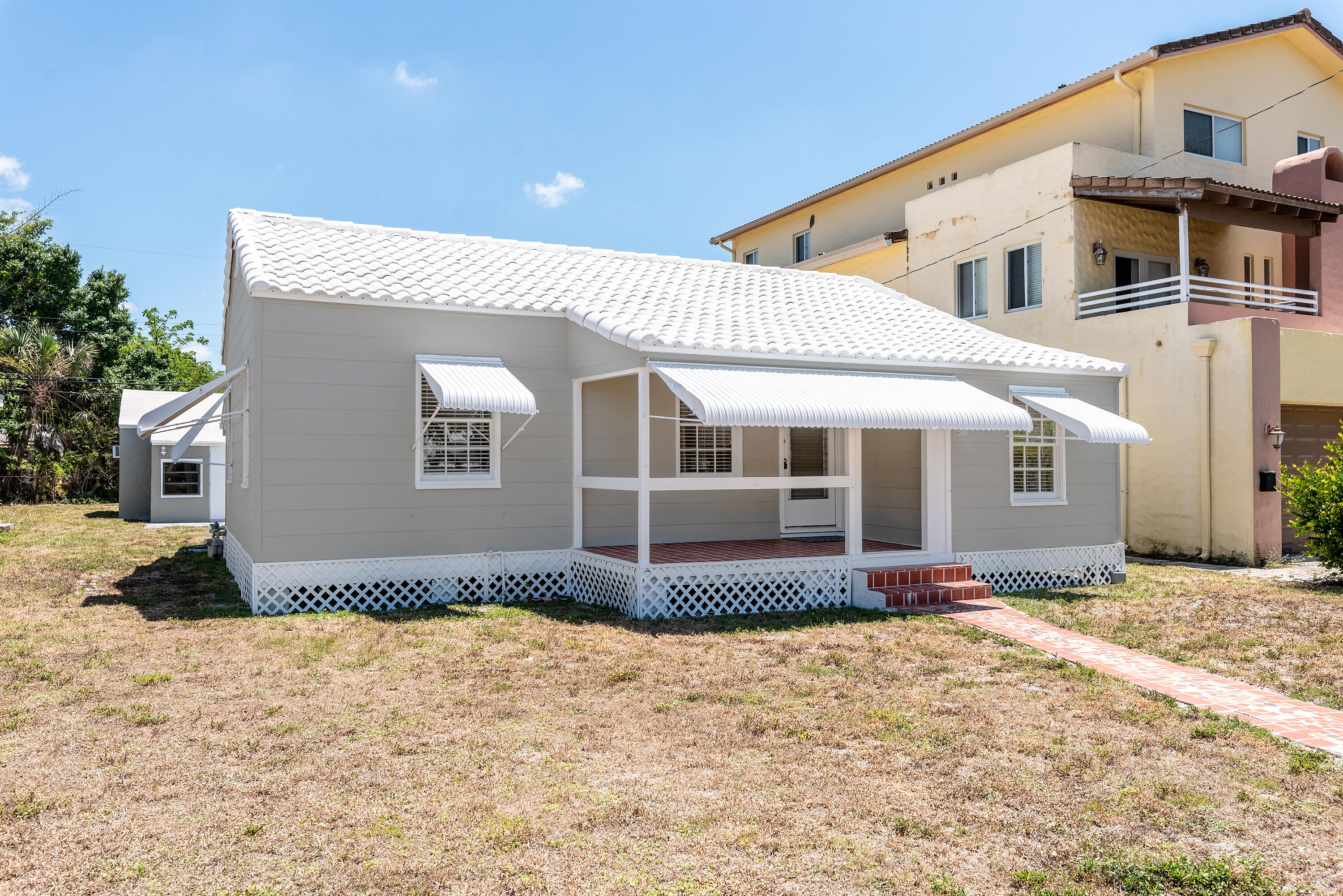 a front view of a house with a yard