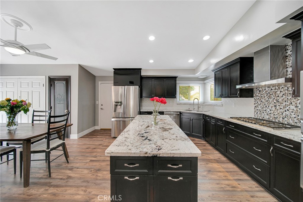 a kitchen with granite countertop counter top space appliances and a center island