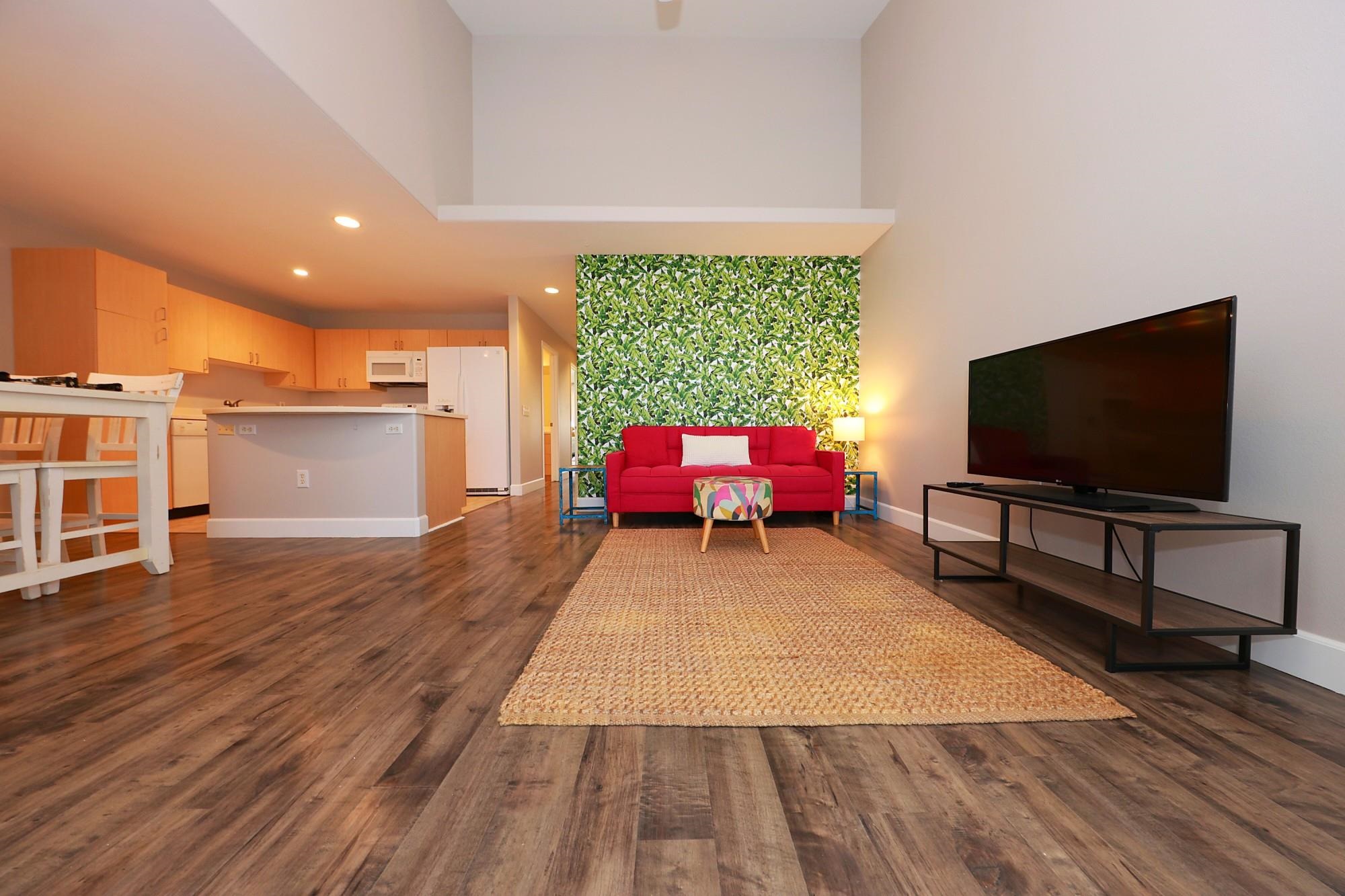 a living room with furniture and a flat screen tv