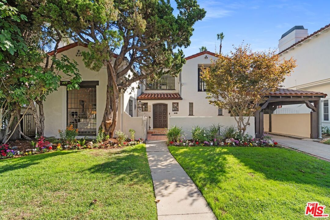 a front view of a house with a garden