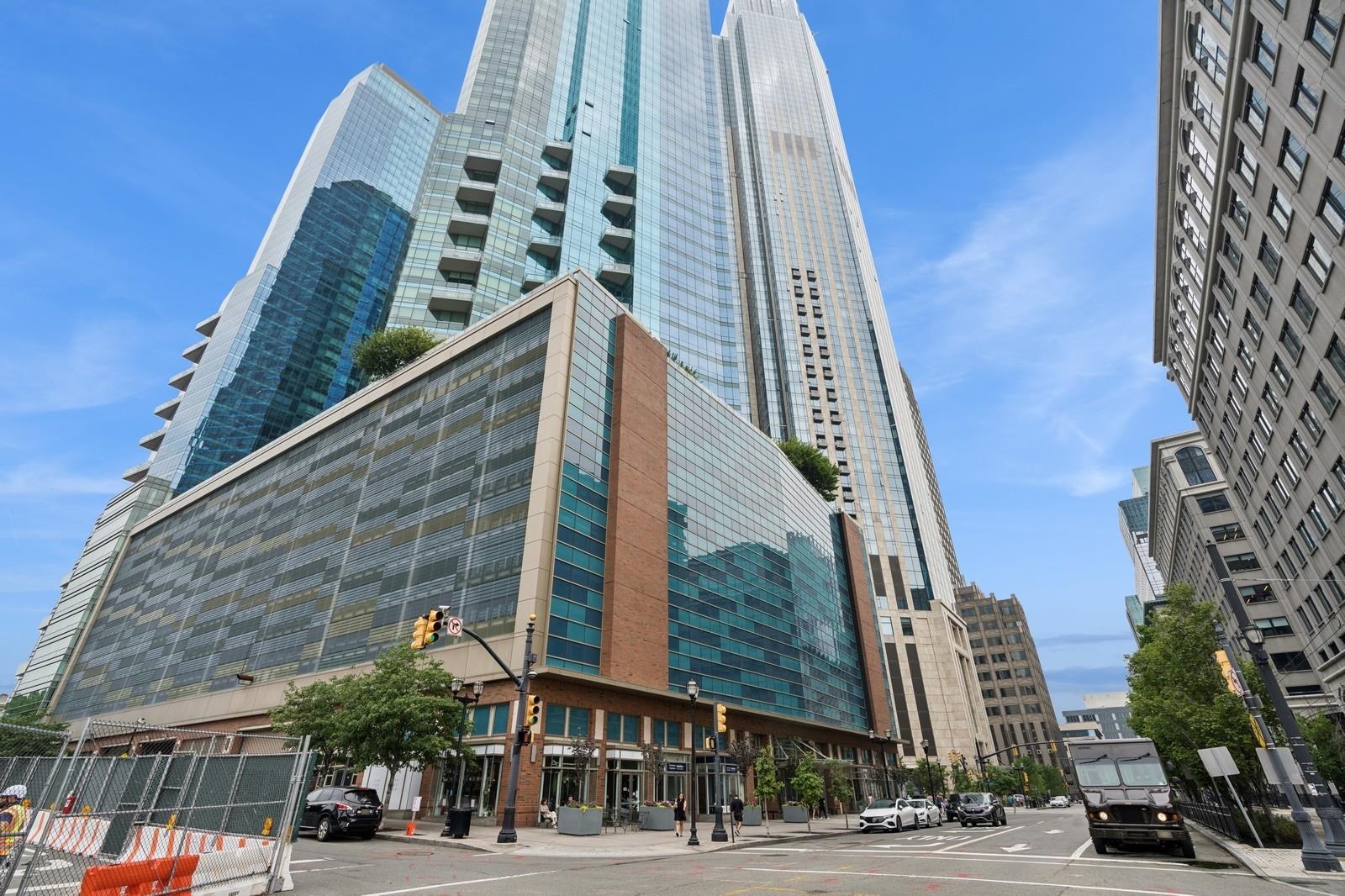 a view of a tall building next to a road