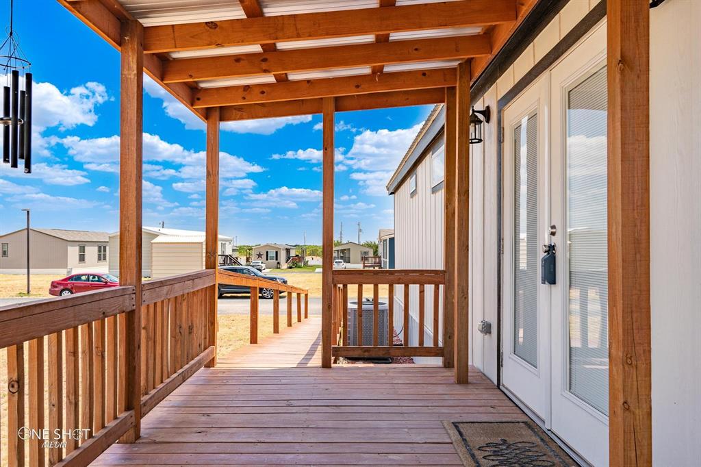 a view of a balcony with wooden floor