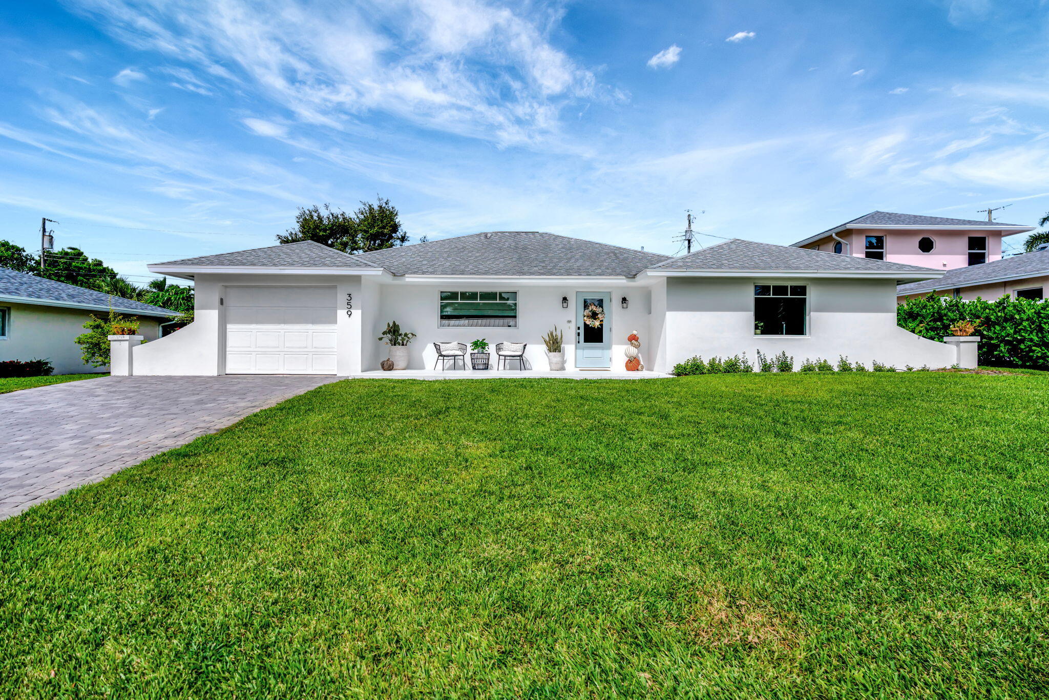 a front view of house with yard and green space