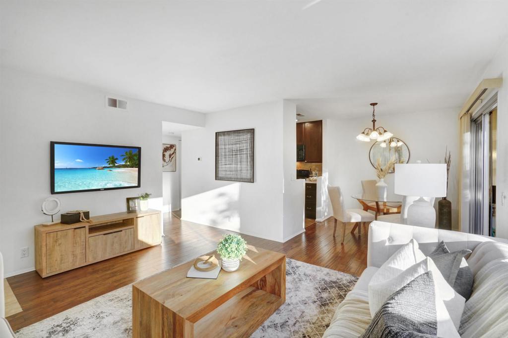 a living room with furniture and wooden floor