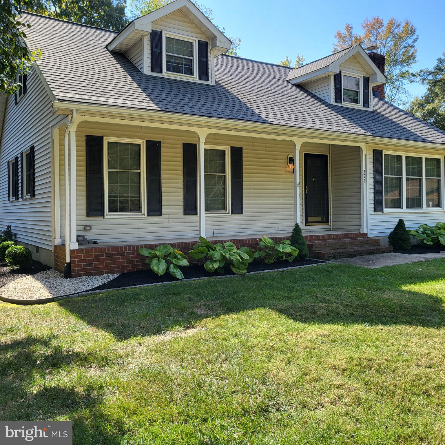 a front view of a house with a yard and porch