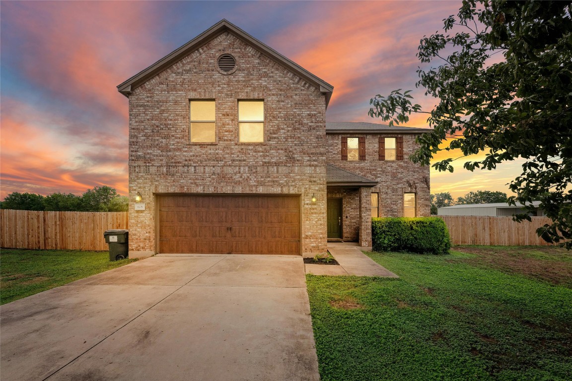 a front view of a house with a yard and garage