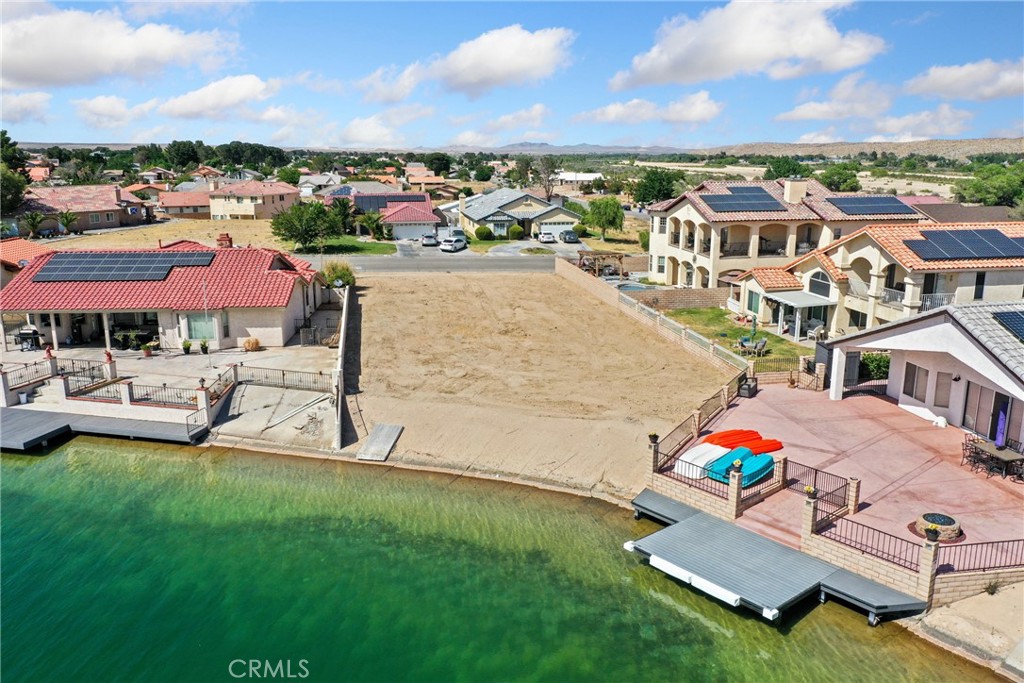 an aerial view of a house with a garden and lake view