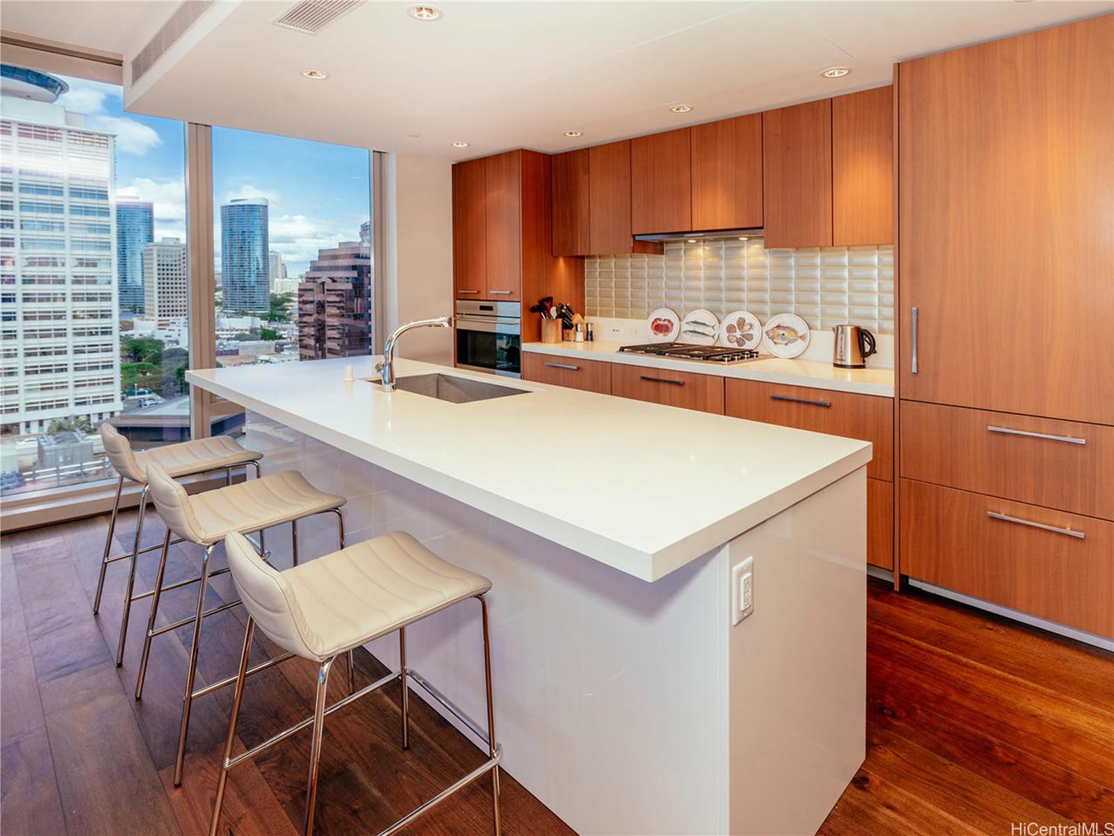 a kitchen with a dining table chairs and a refrigerator