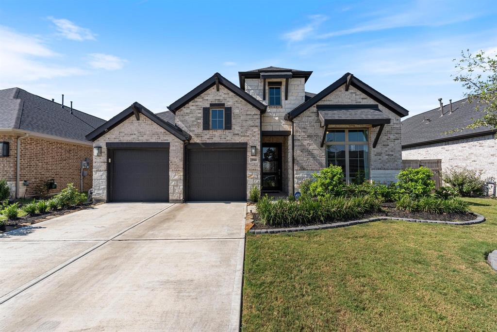 a front view of a house with a yard and garage