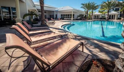 a swimming pool with outdoor seating and yard