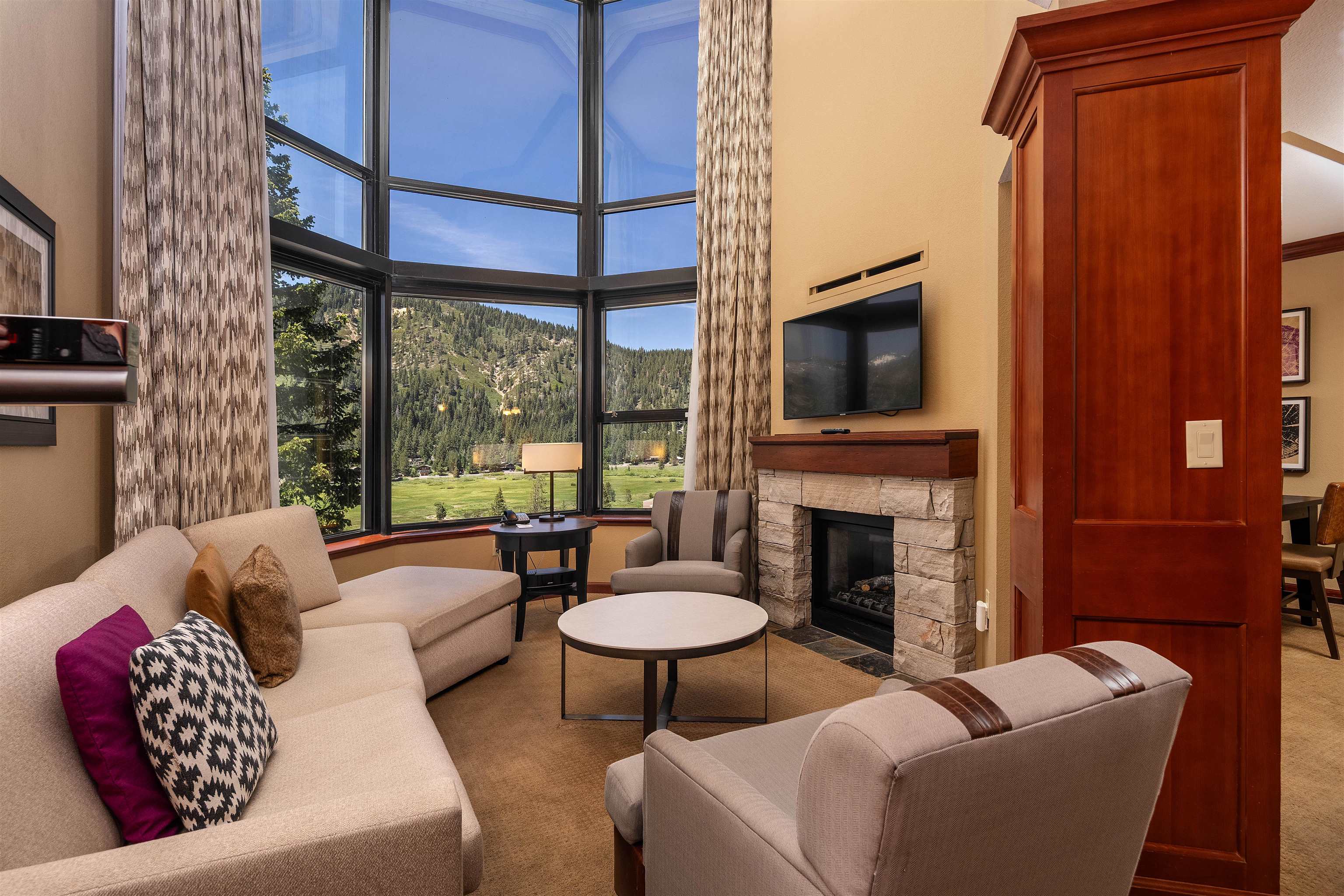 a living room with furniture a fireplace and a flat screen tv