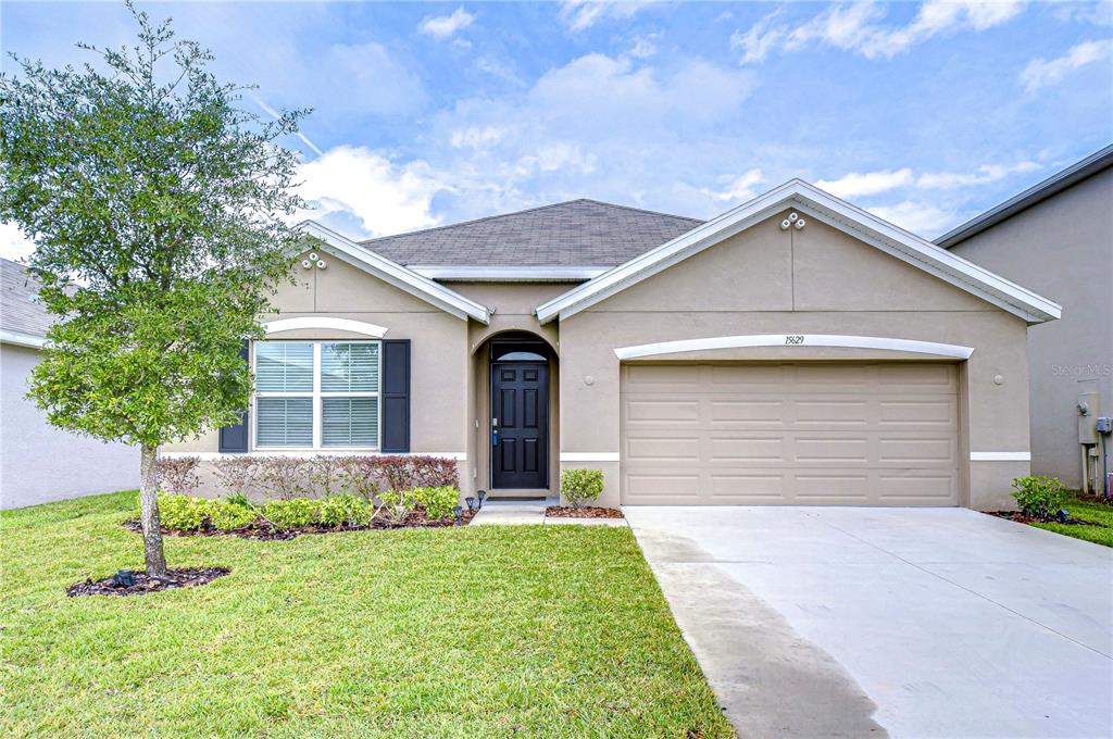 a front view of a house with a yard and garage