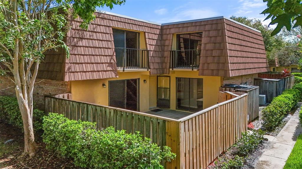 a view of a house with wooden fence