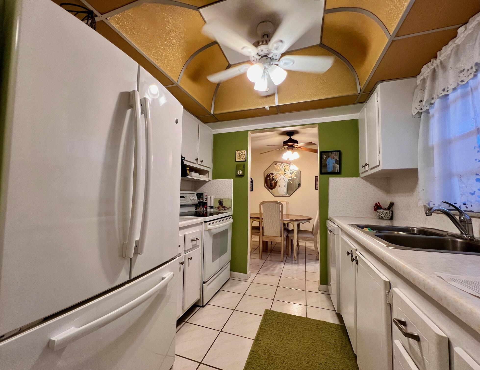 a kitchen with stainless steel appliances granite countertop a sink a stove and a refrigerator