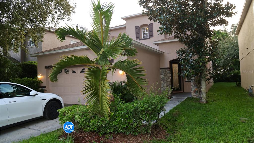 Driveway of this beautiful home with luscious green plants