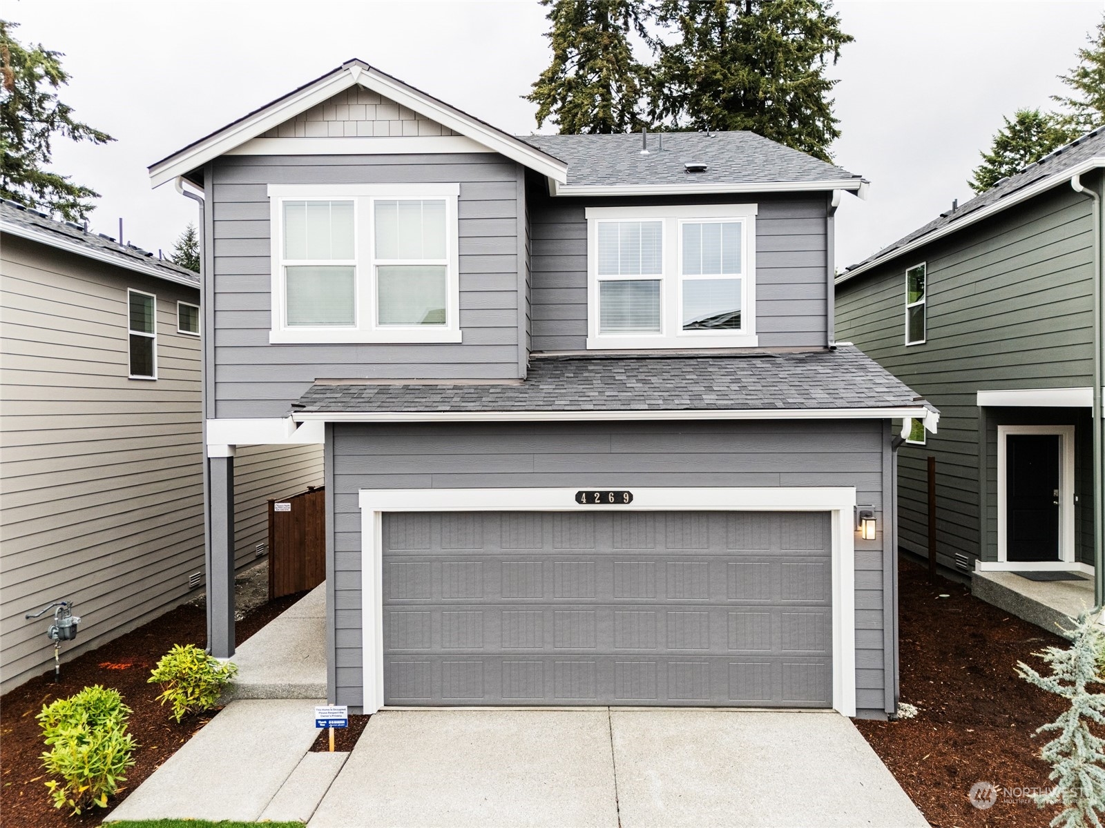 a front view of a house with garage