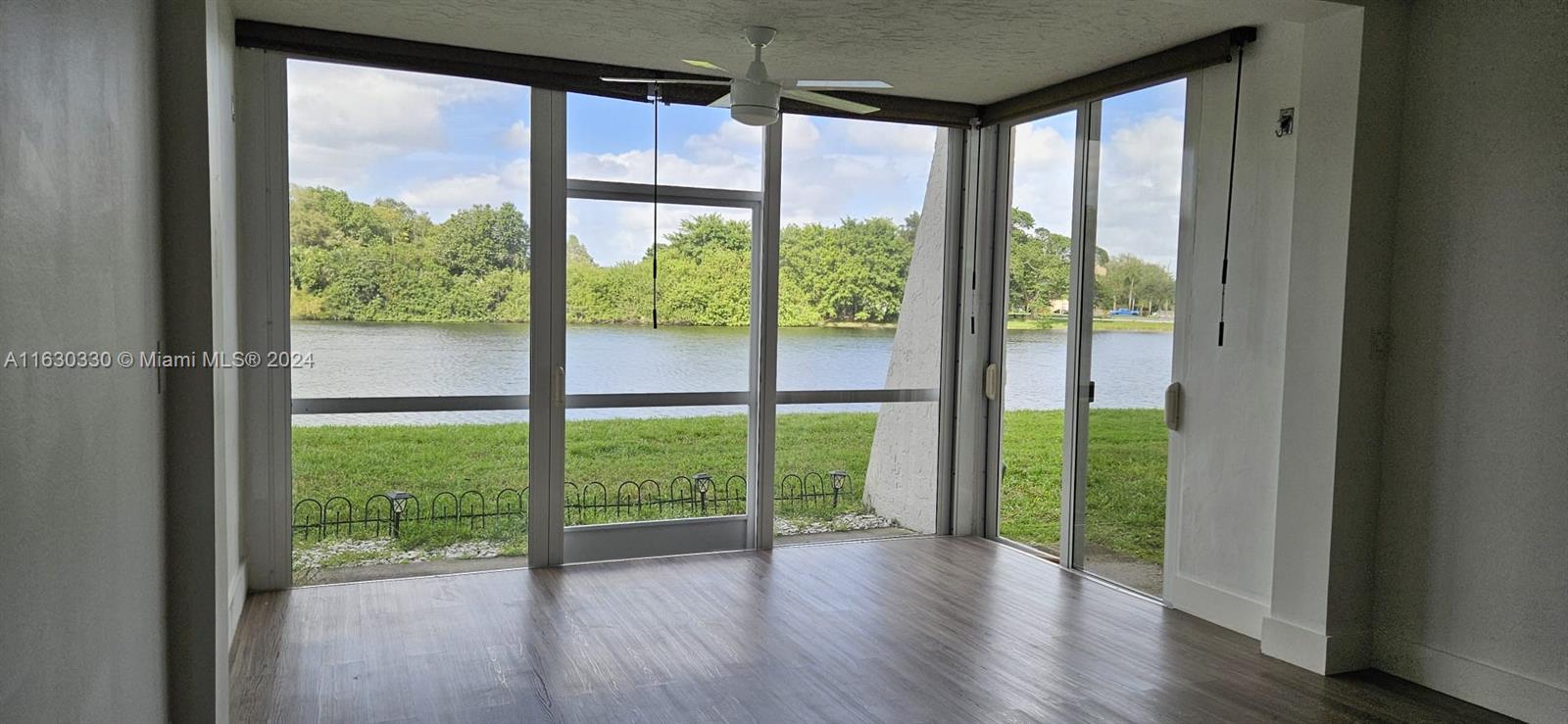 a view of a room with window and wooden floor