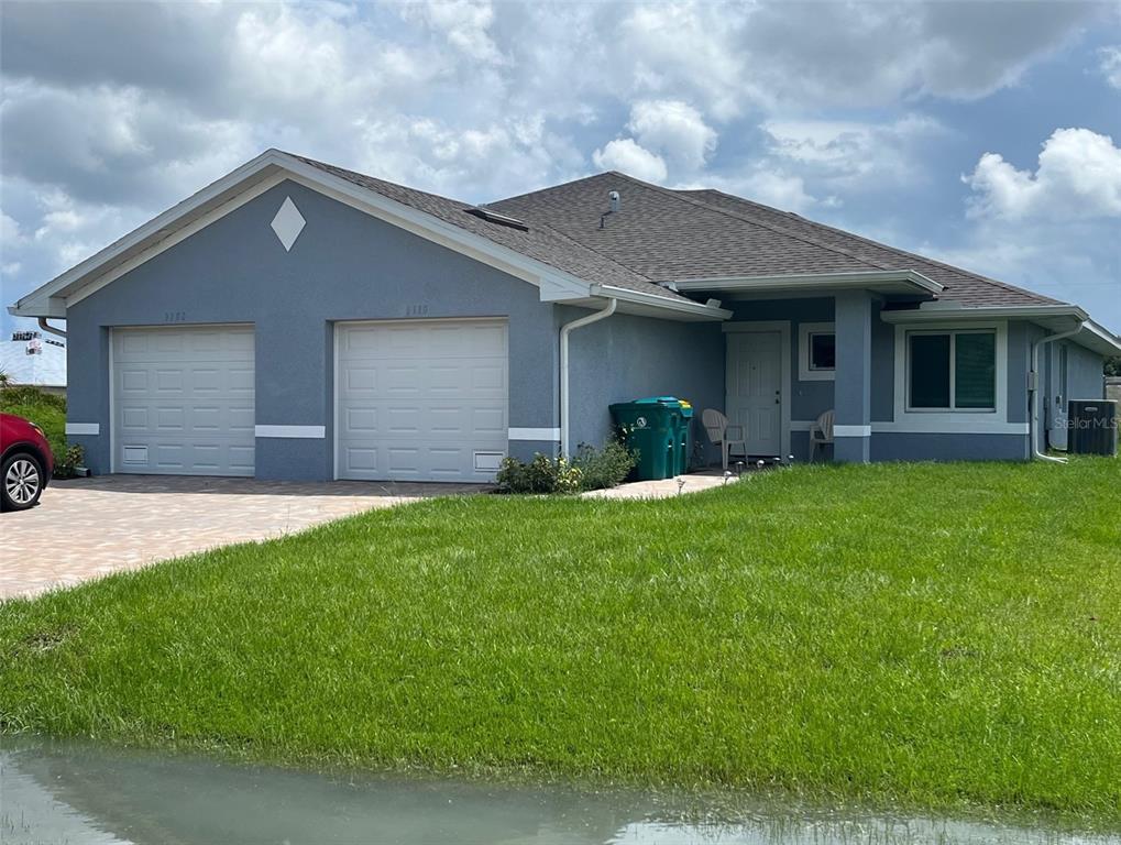 a front view of house with yard and green space