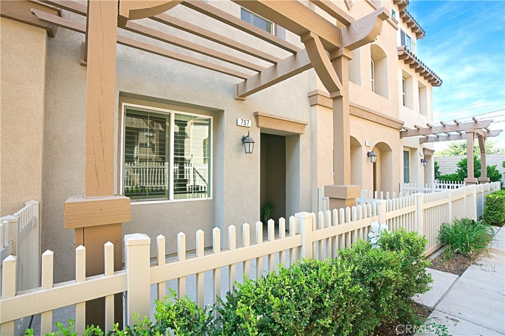 a view of a house with wooden fence