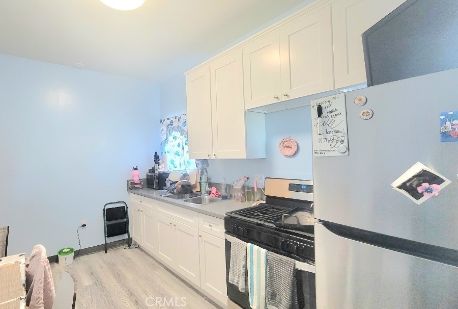 a kitchen with a sink stove and refrigerator