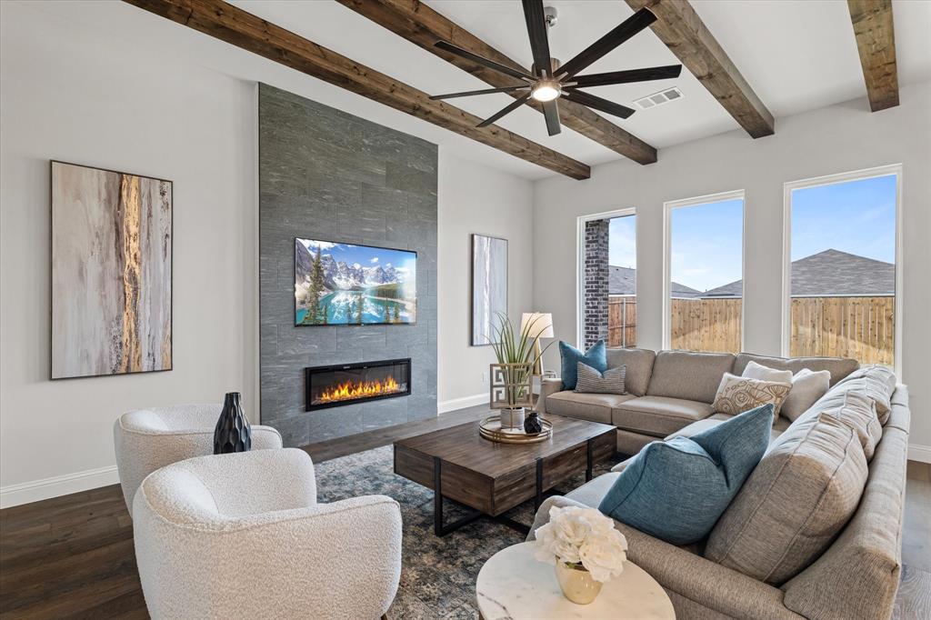 a living room with furniture a fireplace and a large window