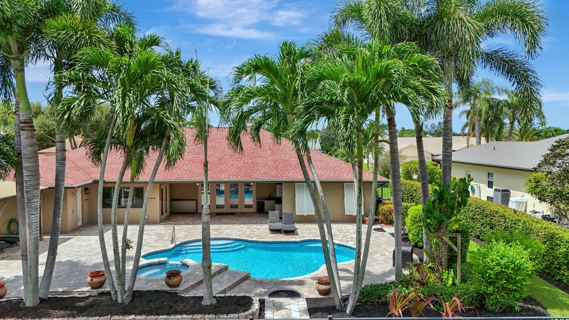 a view of a backyard with swimming pool and furniture