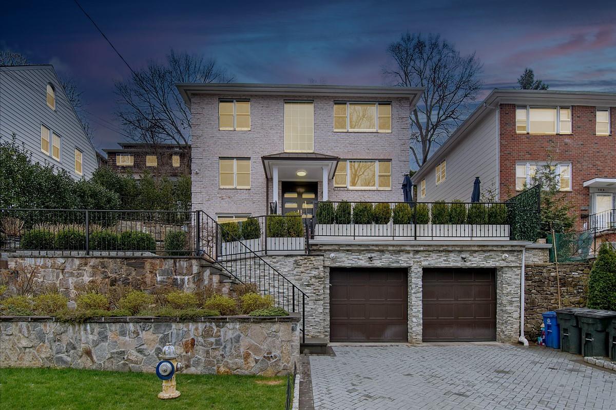 View of front of property with a garage. Virtually-enhanced Twilight photo