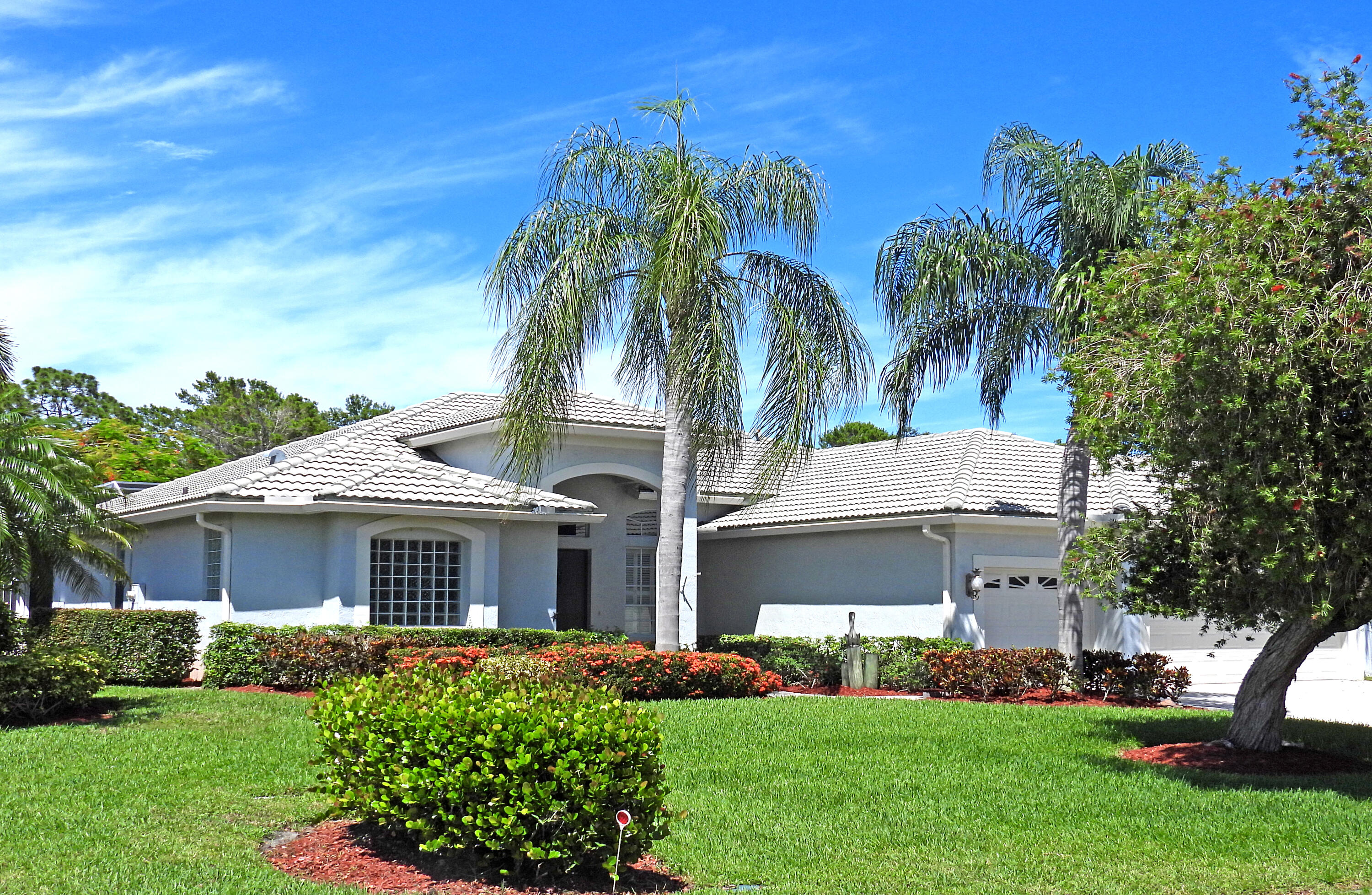 a front view of a house with a garden