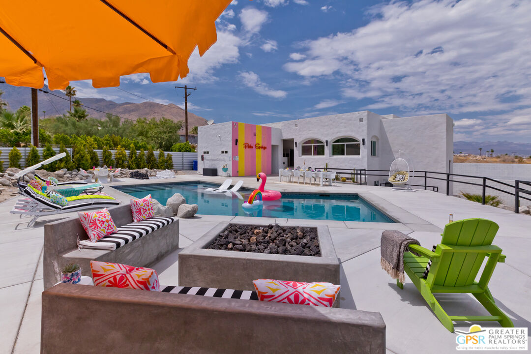 a outdoor living space with furniture and a fireplace