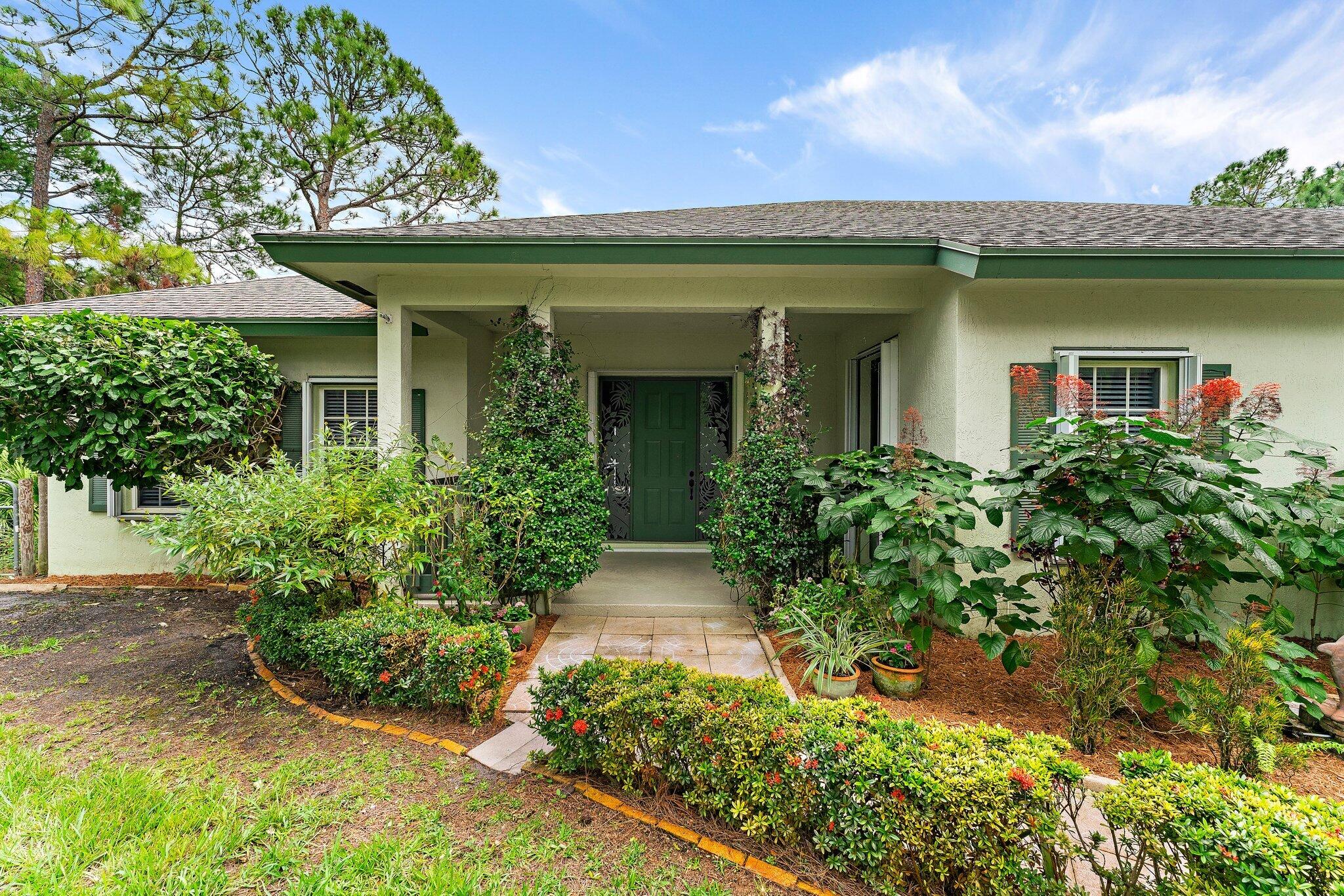 a front view of a house with garden