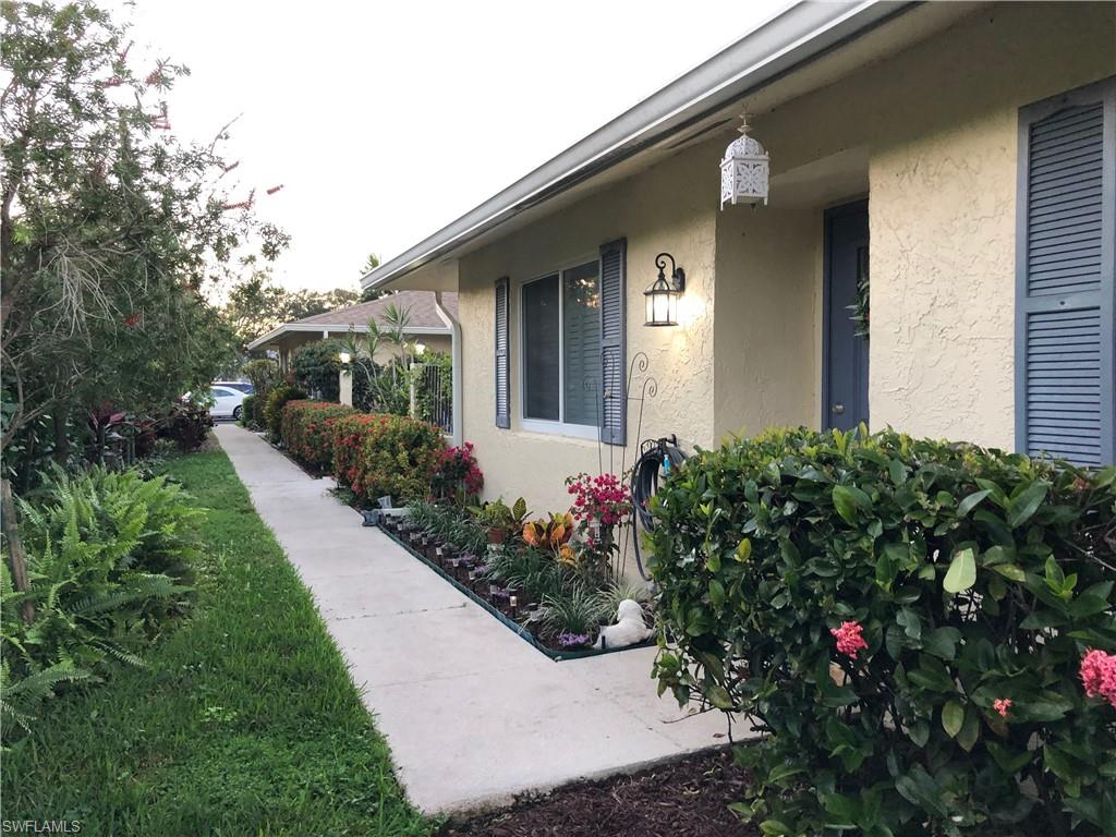 a view of a house with a flower garden