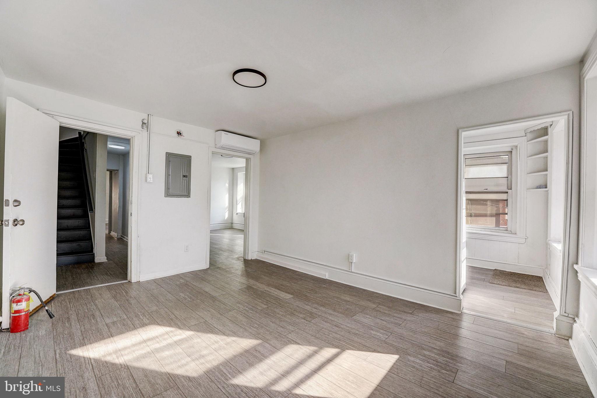 an empty room with wooden floor and closet