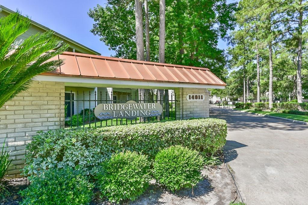 a view of a house with a yard and potted plants