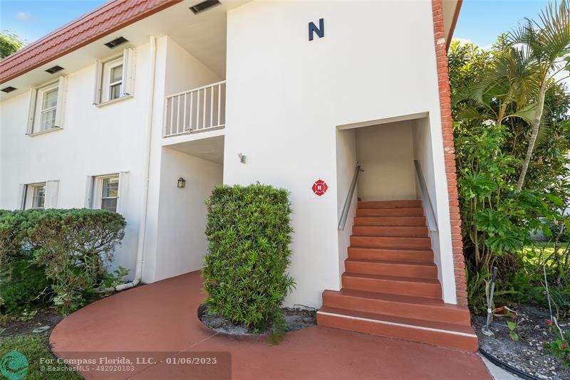 a view of a house with entryway and plants